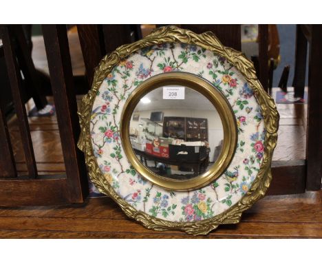 A GILT MOUNTED MIRROR WITH CERAMIC BORDER