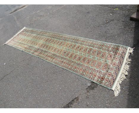 A VINTAGE WOOLLEN RUG APPROX 290 x 80 cm