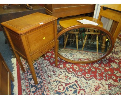 A VINTAGE OAK SEWING/WORK BOX TOGETHER WITH A LARGE OVAL MIRROR