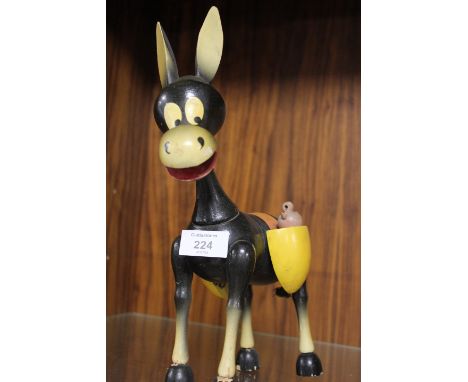 A VINTAGE WOODEN MONEY BOX IN THE SHAPE OF A DONKEY