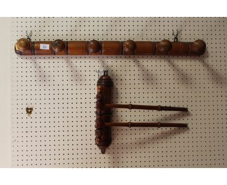 A VINTAGE WOODEN COAT RACK TOGETHER WITH A WALL MOUNTED DOUBLE RAIL