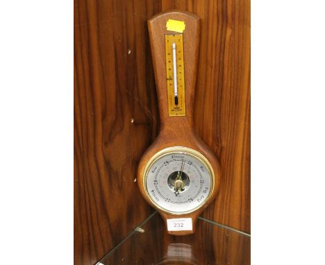 A SMALL WALL MOUNTED BAROMETER