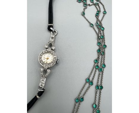 An Art Deco "Platinon" necklace, spectacle set with green paste stone. 108cms in length. Along with a Majex Art Deco style pa