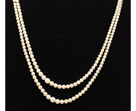 A double strand of graduated cultured pearls with "9ct" stamped to both parts of the white metal clasp. The clasp is set with