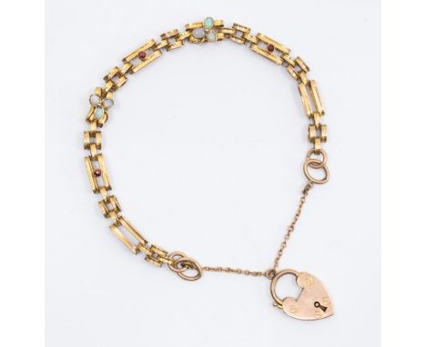An opal and garnet set yellow metal bracelet with a 9ct gold heart padlock clasp, hallmarked with a 1903 import mark for Lond