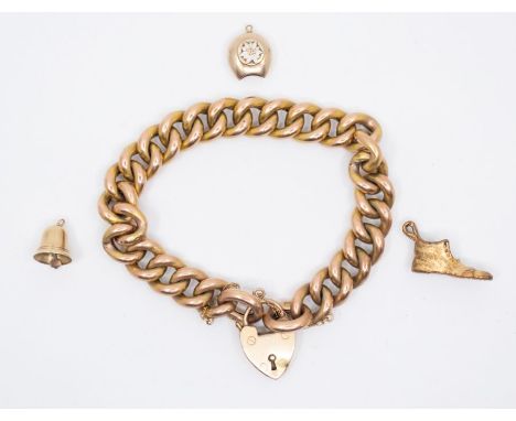 A Charm bracelet, with a 9ct gold heart padlock clasp. The yellow metal chain is stamped "9c". Padlock marked with a Birmingh