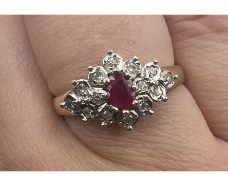 A 9ct gold ruby and diamond set cluster ring, along with a pair of matched 9ct gold diamond and ruby earrings. The ring featu