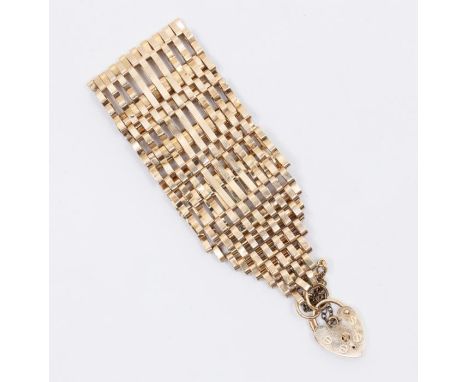 A Vintage 9 bar 9ct gold gate bracelet with heart padlock clasp. Approximate measurements 17 cm in length 3cm width. Total we