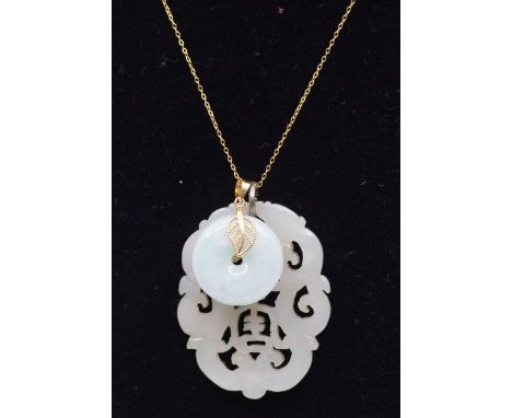 A "Mutton fat" jade carving along with a jadeite "Bi" pendant necklace. The carving is in nephrite jade and measures approxim