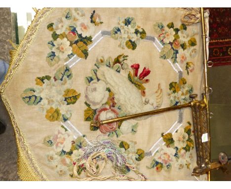 A NEEDLE AND BEAD WORK FIRESCREEN BANNER ON A CLAMP HELD ADJUSTABLE ORMOLU ARM, THE CENTRAL PLUSH WORK PARROT PERCHED ON TWO 