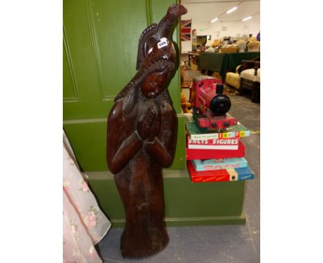 A VINTAGE CARVED HARD WOOD STATUETTE. 