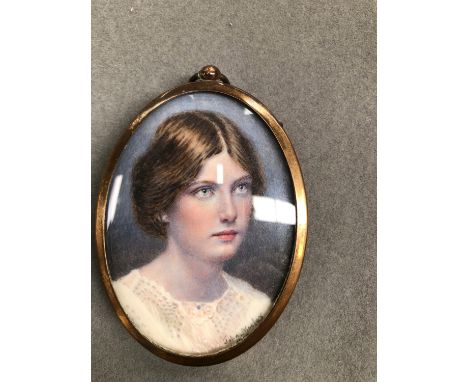 AN ANTIQUE MINIATURE PORTRAIT PAINTING OF A GIRL SIGNED JOHN MOSLEY 1910, WITH A BRASS FRAME.