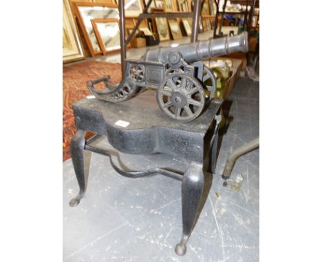 A GEORGIAN IRON FOOTMAN (MODEL CANNON TO BE OFFERED IN A FUTURE SALE).
