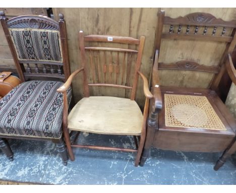 A CANE SEATED COMMODE ELBOW CHAIR WITH WHITE CERAMIC FITTINGS, ANOTHER ELBOW CHAIR AND A MAHOGANY DINING CHAIR