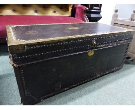 A BRASS EDGED AND CLOSE NAILED LEATHER COVERED CAMPHORWOOD TWO HANDLED TRUNK. W 93cms.