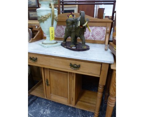 A WHITE MARBLE TOPPED AND TILED BACK PINE WASH STAND WITH AN APRON DRAWER ABOVE A SHELF FLANKED CUPBOARD BETWEEN THE TURNED C