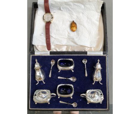A HALLMARKED SILVER CASED SIX PART CRUET SET COMPLETE WITH FOUR SILVER SPOONS, TOGETHER WITH A POLISHED STONE PENDANT AND A T