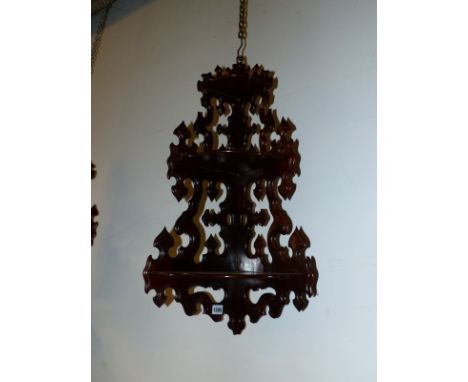 A PAIR OF ROSEWOOD THREE SHELF CORNER BRACKETS ON PIERCED AND CARVED NEOGOTHIC BACK PLATES. H 81cms.