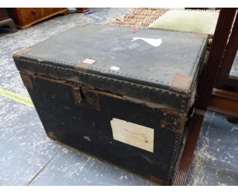 A CLOSE NAILED BLACK CANVAS TWO HANDLED TRUNK.   W 60 x D 43cms.