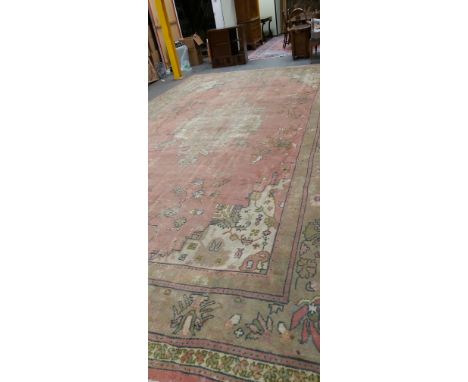 AN OLD COUNTRY HOUSE CARPET PROBABLY INDIAN. 665 x 408cms