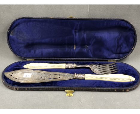 A PAIR OF VICTORIAN SILVER HALLMARKED SILVER CASED FISH SLICE AND FORK SERVERS, WITH IVORY HANDLES. DATED 1864. 