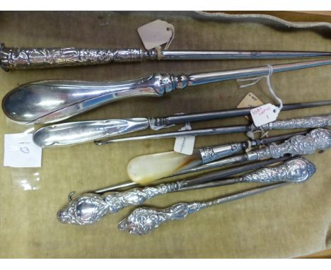 NINE BUTTON HOOKS LARGELY WITH HALLMARKED SILVER HANDLES