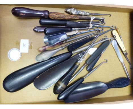 SIXTEEN BUTTON HOOKS WITH EBONY AND OTHER HANDLES, AN EBONY SHOEHORN, THREE SHOE HORN BUTTON HOOK COMBINATIONS AND A NAIL MAN