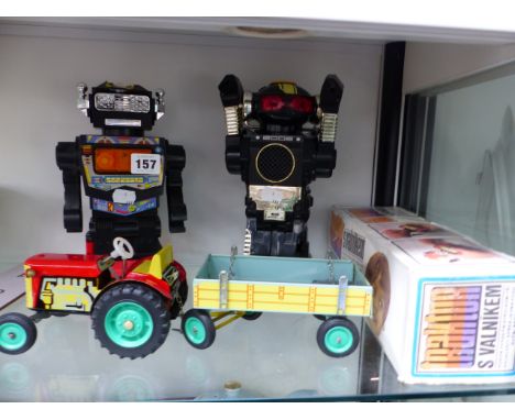 TWO VINTAGE BATTERY OPERATED ROBOT TOYS, AND A TIN PLATE TRACTOR AND TRAILER. 