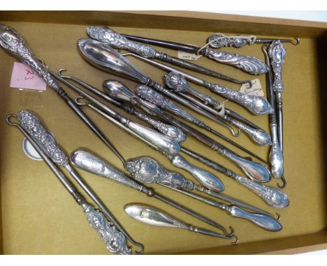 TWENTY THREE STEEL BUTTON HOOKS LARGELY WITH HALLMARKED SILVER HANDLES