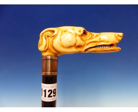 AN EBONY WALKING STICK WITH IRISH SILVER BAND AND IVORY GLASS EYED GREYHOUND HEAD HANDLE