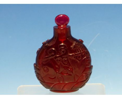A CHINESE RUBY GLASS SNUFF BOTTLE WITH EUROPEAN STOPPER, EACH SIDE CARVED WITH A FISH ON ITS BACK EXHALING A PAVILION.   H 8c