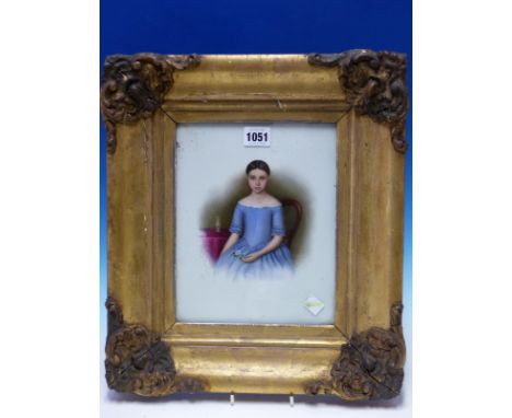 A GILT FRAMED PORTRAIT OF A DARK HAIRED GIRL ON MILK GLASS, SIGNED S CHESTERS 1848, SHE SITS BY A TABLE COVERED BY A MAUVE CL