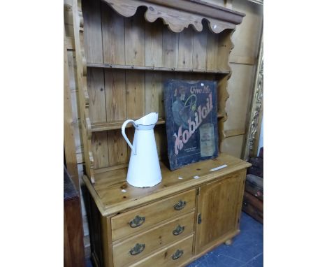 A PINE DRESSER WITH ENCLOSED TWO SHELF BACK, THE BASE WITH A BANK OF THREE DRAWERS FLANKING A CUPBOARD. W 120 x D 47 x H 120c