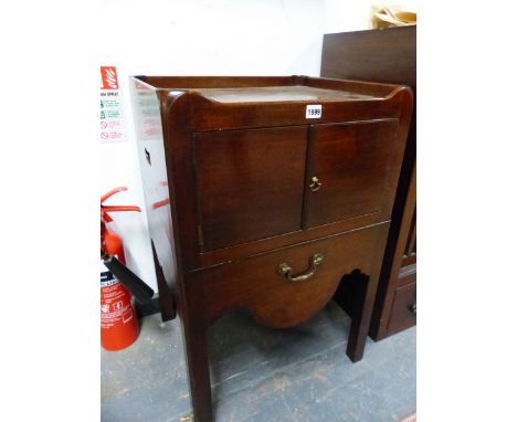 A GEORGE III MAHOGANY NIGHT TABLE WITH GALLERIED TOP, HANDLES PIERCED IN THE SIDES FLANKING A CUPBOARD OVER A DRAW OUT COMMOD