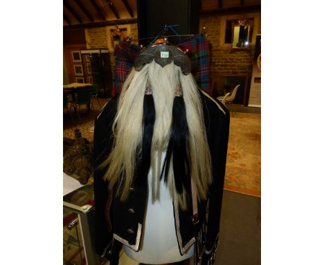 A SCOTTISH PIPERS UNIFORM COMPRISING TARTAN KILT, SASH, SILVER THREAD TRIMMED BLACK JACKET AND OSTRICH FEATHER BUSBY TOGETHER