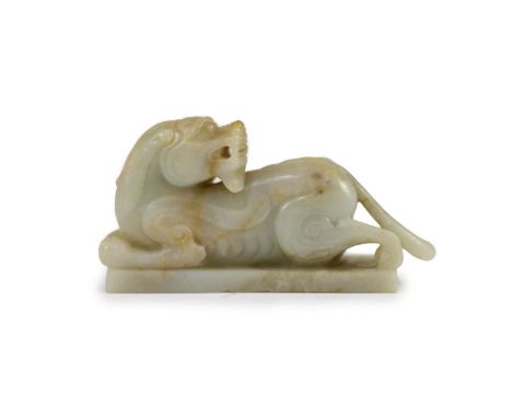   A Chinese Ming archaistic pale celadon and russet jade figure of a pixiu, 16th/17th century,on an integral rectangular base