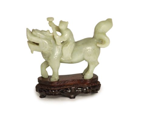  A Chinese pale celadon-grey jade group of a boy riding a qilin, 17th/18th century,13.5cm long, wood stand 