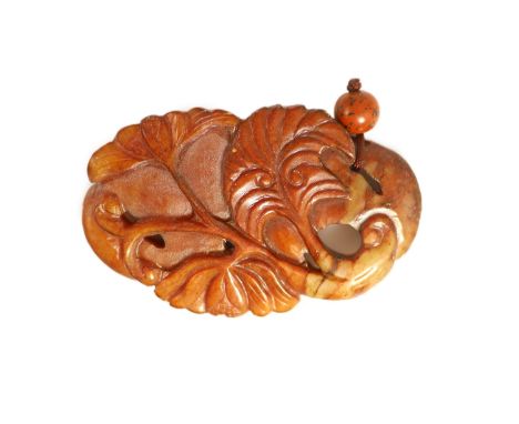   A Chinese russet jade pendant, 19th century,carved in high relief and openwork with a bat, flowers and leaves,7.3cm 