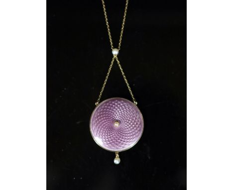   An Edwardian gold, pink guilloche enamel and seed pearl set drop circular pendant necklace,with glazed back, pendant diamet
