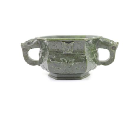   A Chinese archaistic spinach green jade hexagonal censer, 19th century,carved in relief with taotie masks and scrolling chi