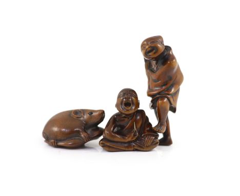   Three Japanese boxwood netsuke, 19th century,the first in the form of a rat eating a seedpod, engraved two character signat