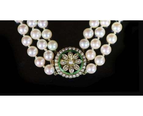   A mid 20th century triple strand cultured pearl choker necklace, with gold, seed pearl and enamel set circular clasp,44cm, 