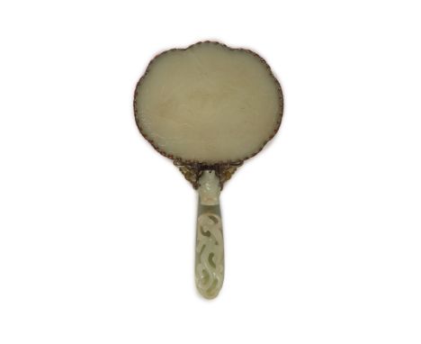   A Chinese pale celadon jade mounted hand mirror, the jade 18th/19th century,the back of the mirror inset with a jade plaque