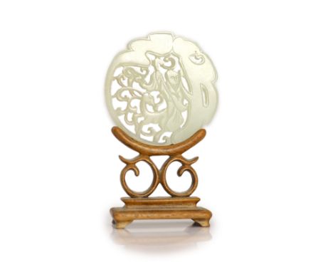   A Chinese pale celadon jade 'Shou Lao' circular plaque, 19th century,carved and pierced with the immortal beside a deer,5.3