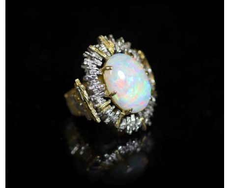   A 1970's? textured two colour 18ct gold and white opal set oval dress ring,the shank indistinctly signed, size L, gross wei