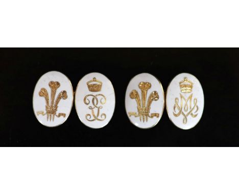   A pair of gold and white enamel oval cufflinks, each gilded with Prince of Wales Feathers and monogram below a coronet,mono