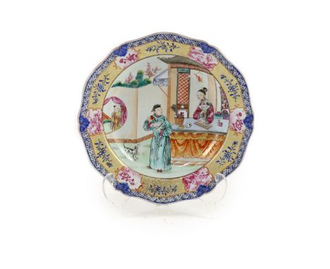   A Chinese export famille rose plate, Qianlong period,finely painted with figures in a pavilion garden with a dog, the lady 