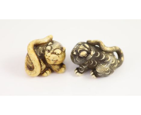   Two Japanese ivory netsuke of a tiger, Edo period, first half 19th century,each with horn inlaid eyes, unsigned,4cm and 5cm