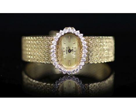   A lady's modern Swiss 14k gold and diamond set manual wind oval wrist watch, on integral 14k gold bracelet,case diameter 23