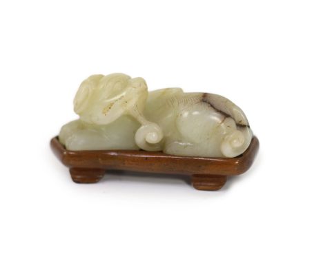   A Chinese pale celadon and brown jade figure of a lion-dog, 18th/19th century,in recumbent pose, Provenance - Mr W G Pullen